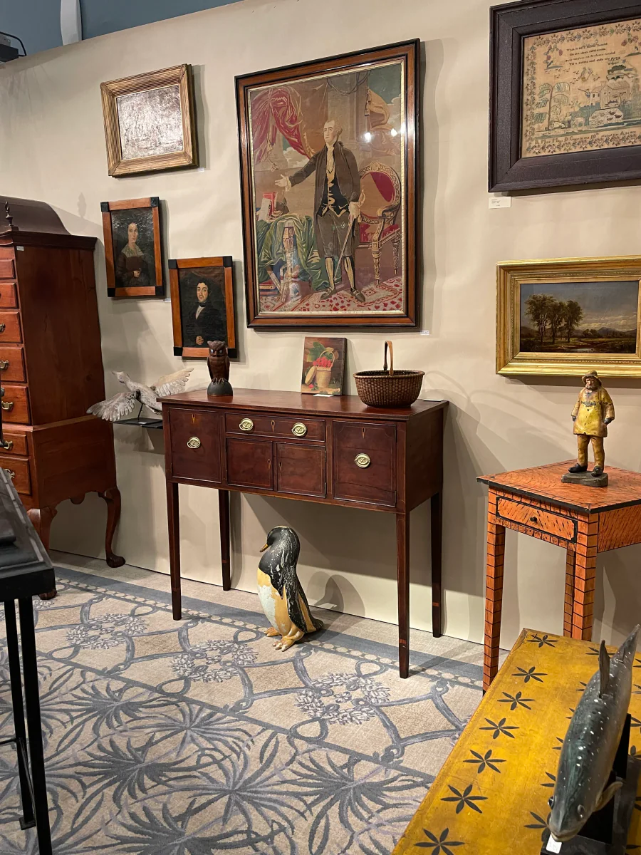 Federal sideboard with early American folk art in a curated gallery setting
