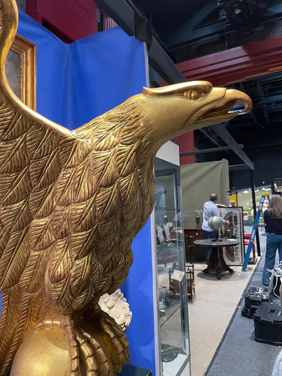 Detail of a gilded American eagle sculpture showing carved feather texture