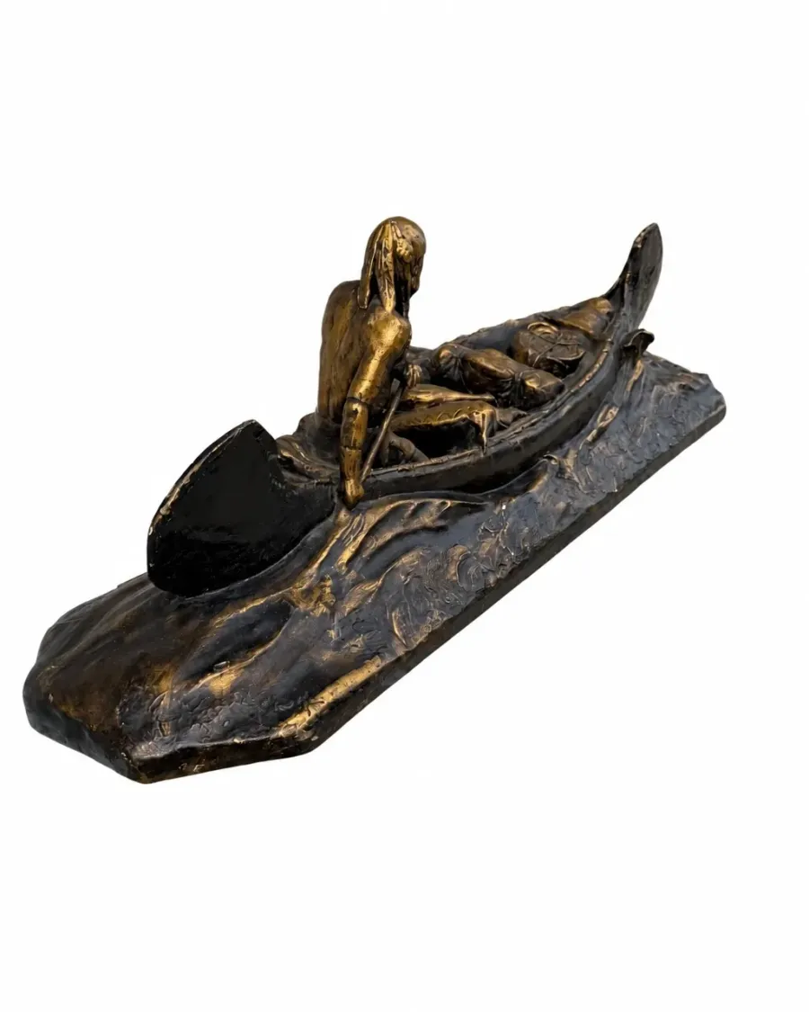 Angled view of the decorative canoe sculpture with paddler