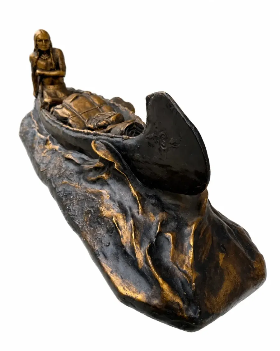 Opposite angled view of the decorative canoe sculpture with paddler