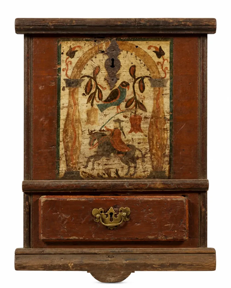 Antique wood chest with hand-painted equestrian folk art, iron hardware, and a brass drawer pull isolated on a clean white background