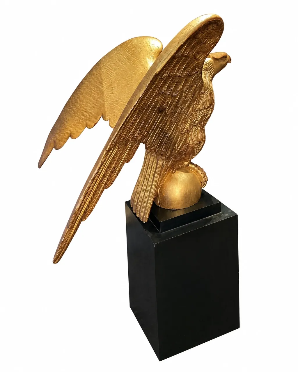 Large gilded eagle sculpture isolated on a white background